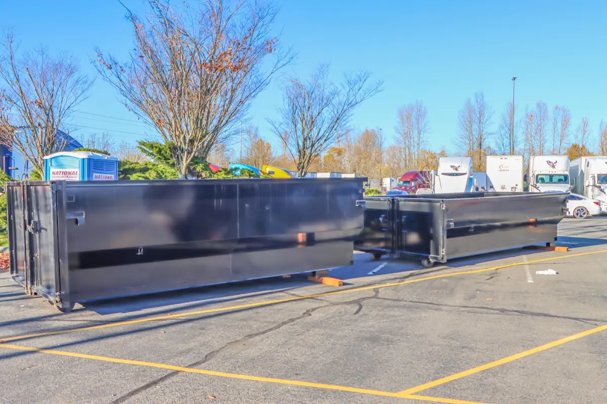 Professional dumpster rental service with roll-off container on residential driveway in Senatobia